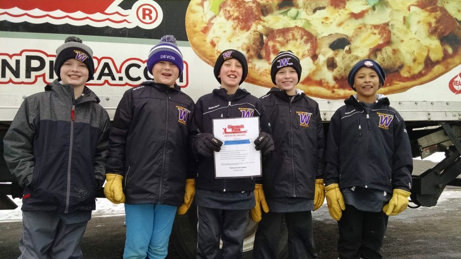 Team of Boys in front of Sign