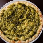 Focaccia,With,Cheese,And,Pesto,On,White,Dish,On,A