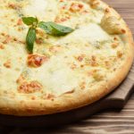 Four,Cheese,Pizza,Quattro,Fromaggi,With,Basil,Leaf,On,A